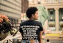 Back view of person wearing t-shirt with empowering message in Chicago street.
